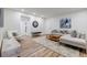 Well-lit living room with light gray sofa, wood floors, and modern decor at 1445 Monroe Ne Dr # C32, Atlanta, GA 30324