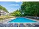 Gorgeous community pool with abundant lounge chairs and landscaping with surrounding buildings at 1445 Monroe Ne Dr # C32, Atlanta, GA 30324