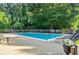 A stunning community pool with chairs and a large deck area on a sunny day at 1445 Monroe Ne Dr # C32, Atlanta, GA 30324