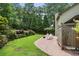 Spacious backyard with a lush lawn, brick patio, and privacy fence, offering an ideal outdoor living space at 300 Stone Mill Trl, Atlanta, GA 30328