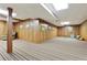 Expansive basement featuring wood-paneled walls and striped floors, ready for customization and entertainment at 300 Stone Mill Trl, Atlanta, GA 30328