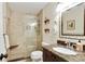 Bathroom featuring a glass shower, neutral tile surround, and granite countertop vanity at 300 Stone Mill Trl, Atlanta, GA 30328