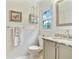 Bright bathroom featuring a marble countertop vanity, white tile surround, and ample natural light at 300 Stone Mill Trl, Atlanta, GA 30328