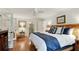 Inviting bedroom with wood floors, a ceiling fan, and a modern accent wall headboard at 300 Stone Mill Trl, Atlanta, GA 30328