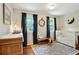 Bright Bedroom features hardwood floors, dual windows, and a white crib, creating a cozy, inviting space at 300 Stone Mill Trl, Atlanta, GA 30328