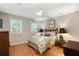 Comfortable bedroom showcasing hardwood floors, bright windows, and charming decor, ideal for relaxation at 300 Stone Mill Trl, Atlanta, GA 30328