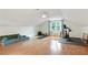 Spacious bonus room with hardwood floors, natural light, and a ceiling fan at 300 Stone Mill Trl, Atlanta, GA 30328