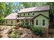 Charming two-story home with a welcoming front porch and lush, mature landscaping at 300 Stone Mill Trl, Atlanta, GA 30328