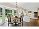 Eat-in kitchen featuring a round table near a bay window and stainless steel appliances with white cabinets at 300 Stone Mill Trl, Atlanta, GA 30328
