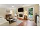 Bright and airy living room featuring a fireplace, built-in shelving, and access to the backyard at 300 Stone Mill Trl, Atlanta, GA 30328