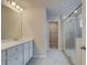 Bathroom features a walk-in shower and a double vanity with bright modern lighting at 616 Gratton Ln, Mcdonough, GA 30253