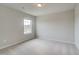A cozy bedroom features neutral walls, soft carpet, and a bright window for natural light at 616 Gratton Ln, Mcdonough, GA 30253