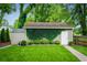 Backyard view of the garage and shed with beautiful green grass and ivy-covered walls at 1232 Lucile Sw Ave, Atlanta, GA 30310