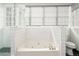 Bright bathroom with a soaking tub, a separate shower, and white tiled surround at 1232 Lucile Sw Ave, Atlanta, GA 30310