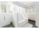 Bright bathroom featuring a soaking tub, a separate shower, and ample natural light at 1232 Lucile Sw Ave, Atlanta, GA 30310