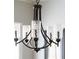 Close up shot of a rustic chandelier with glass candle covers and bronze hardware at 1232 Lucile Sw Ave, Atlanta, GA 30310