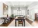 Dining room with a chandelier, coffered ceilings, a wooden table, and lots of natural light at 1232 Lucile Sw Ave, Atlanta, GA 30310
