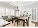 A dining room with modern furniture and a view into the cozy living room and fireplace at 1232 Lucile Sw Ave, Atlanta, GA 30310