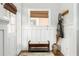 Cozy entryway with a bench, coat rack, and decorative wainscoting, offering a functional and stylish space at 1232 Lucile Sw Ave, Atlanta, GA 30310