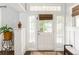 Bright entryway featuring a white door with glass panels and transom, complemented by light walls and hardwood floors at 1232 Lucile Sw Ave, Atlanta, GA 30310