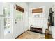 Charming foyer with beadboard accents, natural light, and a bench with storage, providing a warm welcome to guests at 1232 Lucile Sw Ave, Atlanta, GA 30310