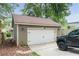 Spacious detached garage with an automatic door and adjacent parking area at 1232 Lucile Sw Ave, Atlanta, GA 30310