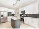 A modern kitchen with white cabinets, stainless steel appliances, and a gray kitchen island at 1232 Lucile Sw Ave, Atlanta, GA 30310