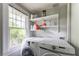Laundry room with a Samsung washer and dryer unit and shelving above at 1232 Lucile Sw Ave, Atlanta, GA 30310
