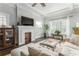 Bright living room with fireplace, hardwood floors, and large windows, creating a welcoming atmosphere at 1232 Lucile Sw Ave, Atlanta, GA 30310