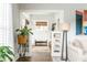 Bright living room with hardwood floors, plant accents, and view to entryway at 1232 Lucile Sw Ave, Atlanta, GA 30310