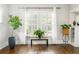 Bright living room with hardwood floors, plants, and large windows, creating a welcoming atmosphere at 1232 Lucile Sw Ave, Atlanta, GA 30310