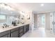 Bathroom featuring double vanity, a large mirror, white cabinets, and a glass shower at 2561 Adair Ridge Ct, Decatur, GA 30034