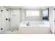 Bathroom features a shower and a separate soaking tub with white subway tiles at 2561 Adair Ridge Ct, Decatur, GA 30034
