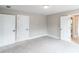 Bedroom has carpet flooring, three doors, and neutral colored walls at 2561 Adair Ridge Ct, Decatur, GA 30034