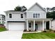 Charming two-story home with gray siding, manicured lawn, and attached two-car garage at 2561 Adair Ridge Ct, Decatur, GA 30034