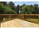 A newly constructed back deck offers outdoor living with views of mature trees at 3620 Darwin Pl, Duluth, GA 30096
