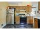 Traditional kitchen with wooden cabinetry, essential appliances, and a black and white patterned floor at 3620 Darwin Pl, Duluth, GA 30096
