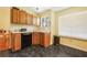 Functional kitchen featuring wooden cabinets, essential appliances, and a window with natural light at 3620 Darwin Pl, Duluth, GA 30096