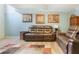 Comfortable seating in a living room featuring laminate flooring and framed artwork at 3620 Darwin Pl, Duluth, GA 30096