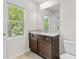 Bathroom featuring a vanity with granite countertops, a window, and a toilet at 5843 Taka Ln, Lithonia, GA 30038