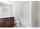 Bathroom with a single sink vanity, granite counters, white toilet and a tub with shower at 5843 Taka Ln, Lithonia, GA 30038