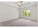 Carpeted bedroom with a ceiling fan and a window view at 5843 Taka Ln, Lithonia, GA 30038