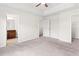 Bright bedroom with neutral carpet, ceiling fan, and ensuite bathroom access at 5843 Taka Ln, Lithonia, GA 30038