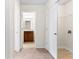 Hallway view with access to the bathroom, laundry room, and linen closet at 5843 Taka Ln, Lithonia, GA 30038