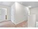 Bright hallway with carpet and white doors leading to rooms at 5843 Taka Ln, Lithonia, GA 30038