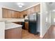 Well-equipped kitchen with wood cabinets, granite countertops, and modern appliances at 5843 Taka Ln, Lithonia, GA 30038
