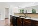 Modern kitchen featuring granite countertops, stainless steel sink, and wooden cabinetry at 5843 Taka Ln, Lithonia, GA 30038