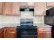 Highlights a black oven, granite countertops, wood cabinets, and tile backsplash at 5843 Taka Ln, Lithonia, GA 30038