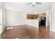 Sunlit living area with hardwood floors, ceiling fan, and an open view into the kitchen at 5843 Taka Ln, Lithonia, GA 30038