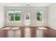 Bright living room with hardwood floors, natural light, and a glass door at 5843 Taka Ln, Lithonia, GA 30038